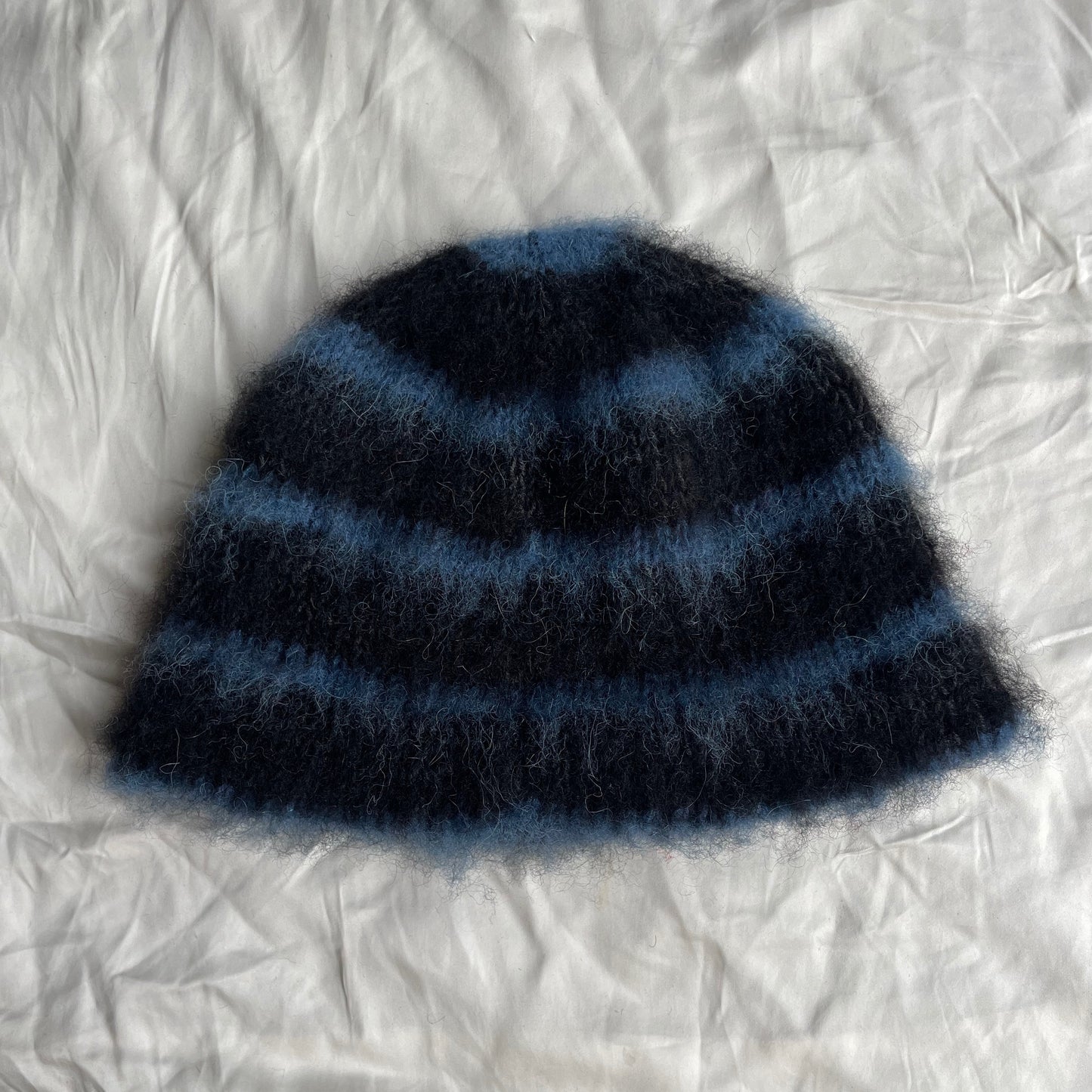 Black beanie with blue stripes