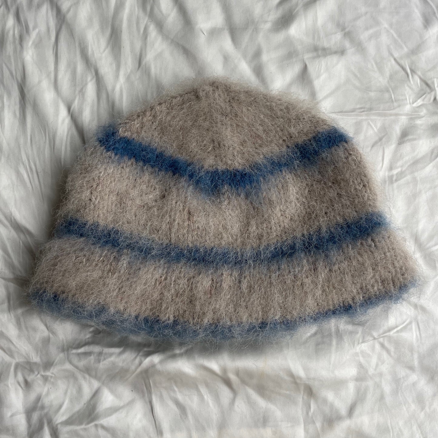 Beige beanie with blue stripes